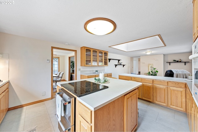 970 Kalmia St, Junction City, OR 97448 - kitchen with a kitchen island, glass insert cabinets, a skylight, light tile patterned flooring, and light countertops
