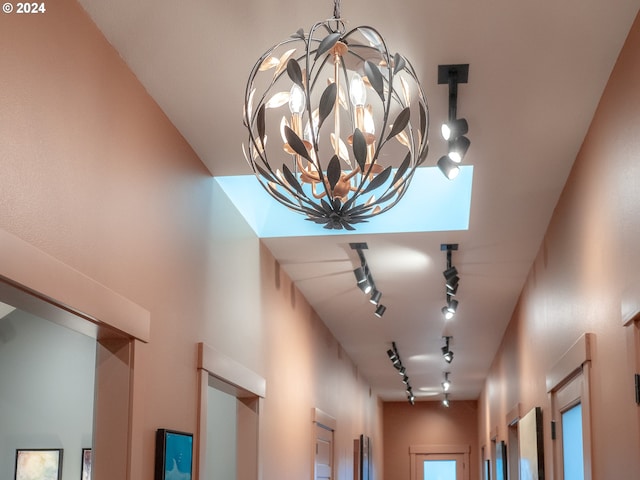 room details featuring a notable chandelier and rail lighting