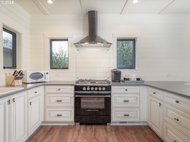 kitchen with black range with gas cooktop, dark wood-type flooring, exhaust hood, and a wealth of natural light