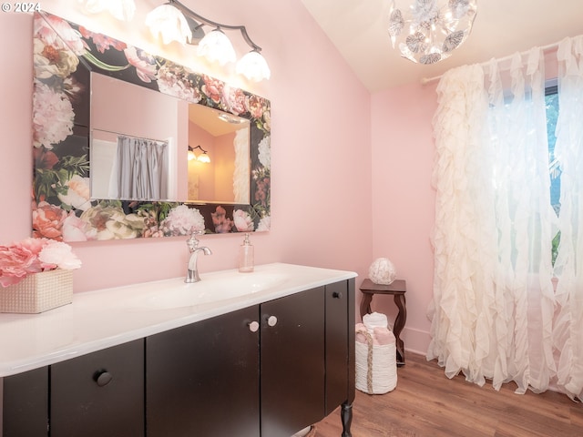 bathroom featuring vaulted ceiling, vanity, and hardwood / wood-style floors