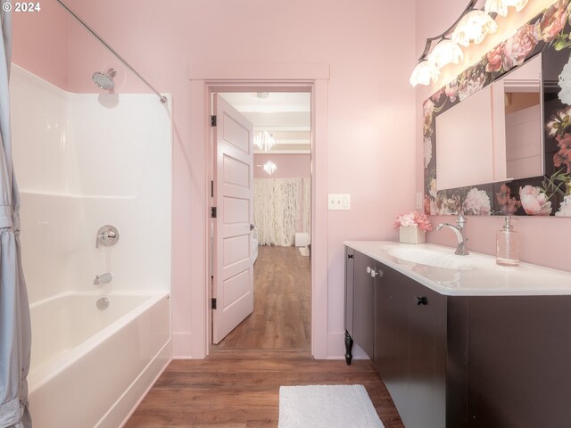 bathroom featuring hardwood / wood-style floors, shower / washtub combination, and vanity