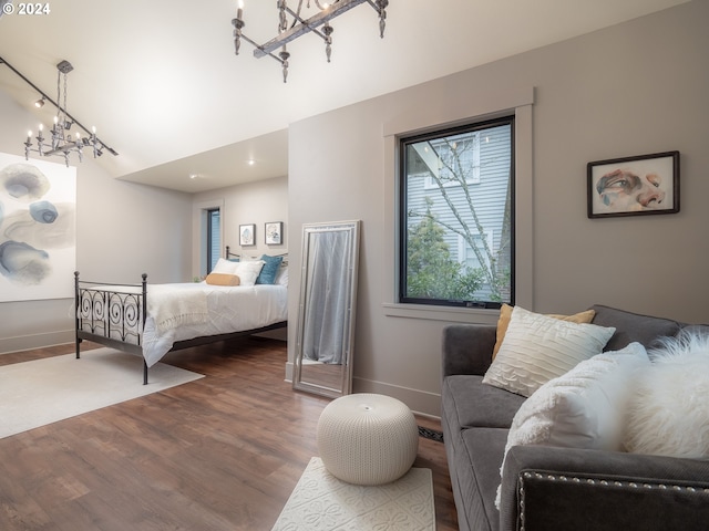 bedroom featuring dark hardwood / wood-style flooring and an inviting chandelier