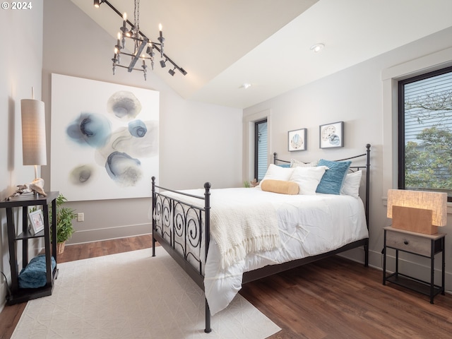 bedroom with lofted ceiling, a chandelier, and light hardwood / wood-style flooring