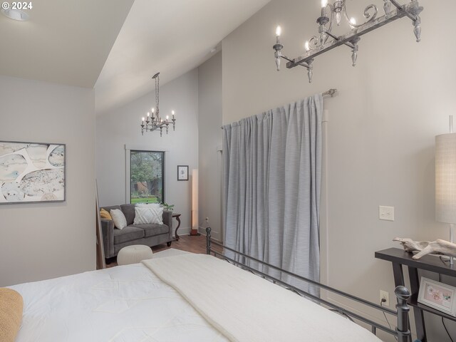 bedroom with an inviting chandelier, dark hardwood / wood-style floors, and high vaulted ceiling