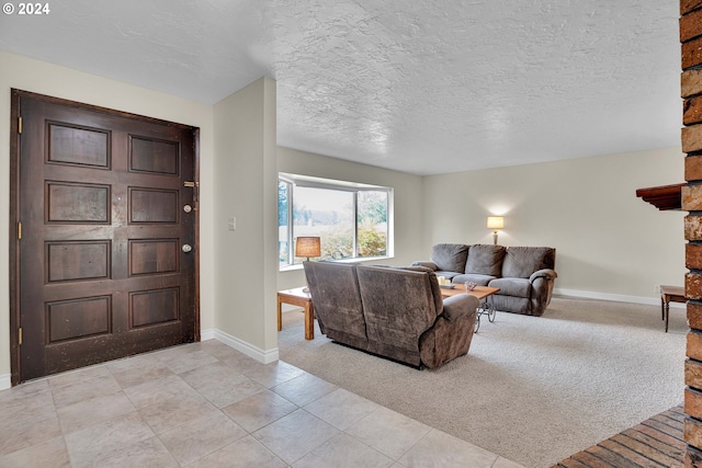 living room with a textured ceiling and light colored carpet