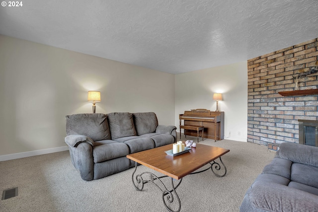 living room featuring carpet flooring, a textured ceiling, and a brick fireplace