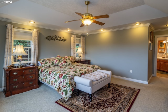 bedroom with connected bathroom, ceiling fan, crown molding, and light colored carpet