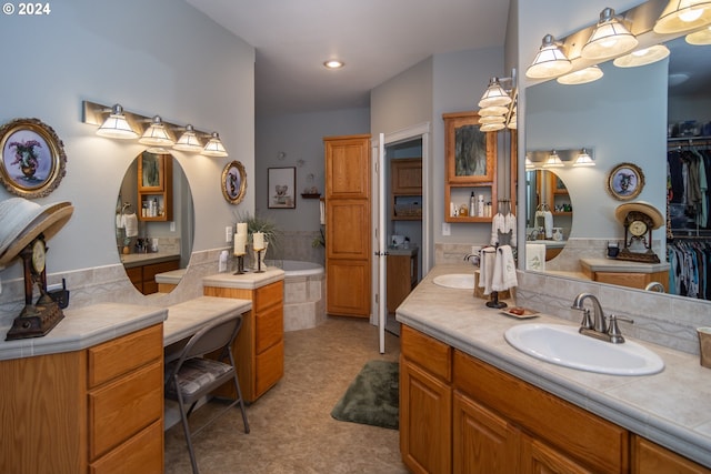 bathroom with vanity and a tub