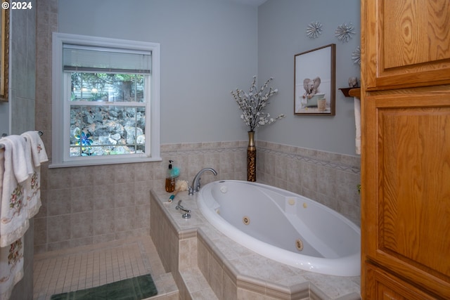 bathroom featuring tiled bath and tile patterned floors