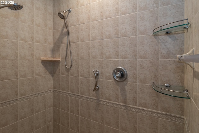 bathroom with a tile shower