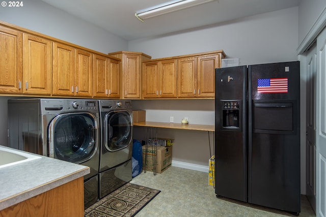 laundry room with washer and dryer and cabinets