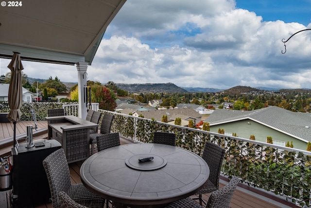 balcony with outdoor dining space and a mountain view