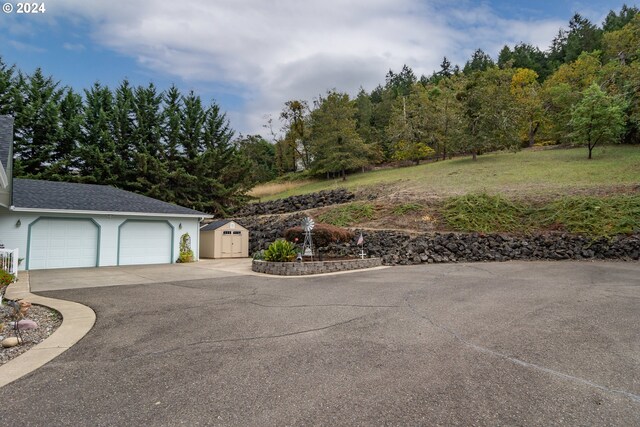 ranch-style home featuring a garage, a mountain view, and a porch