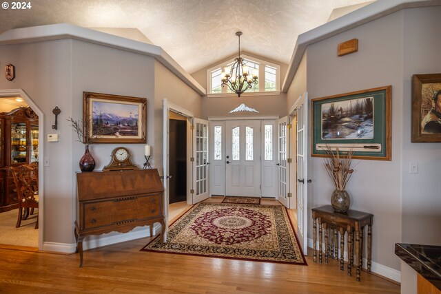 carpeted living room with a textured ceiling, ceiling fan, and vaulted ceiling