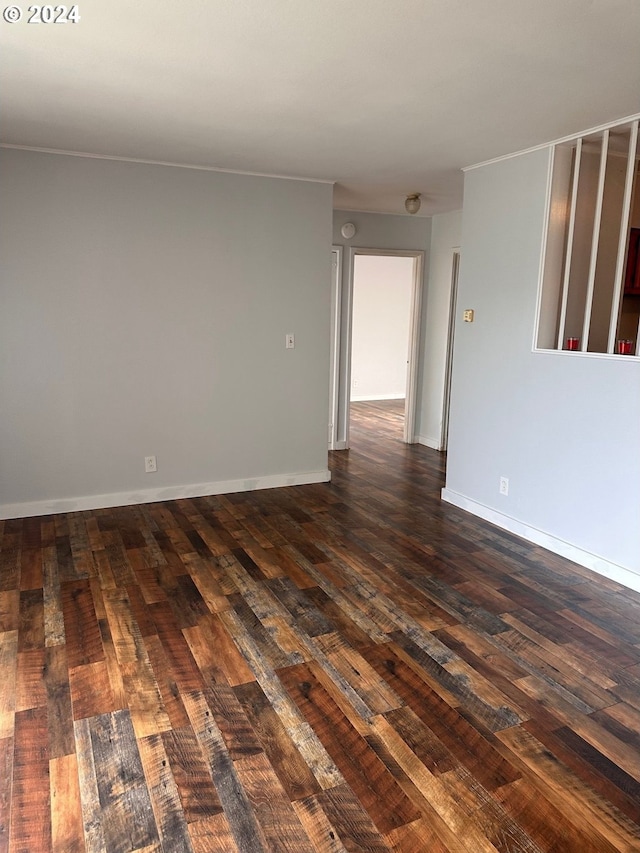 1106 N Myrtle Rd, Myrtle Creek, OR 97457 - unfurnished room featuring dark wood-type flooring, crown molding, and a smoke detector
