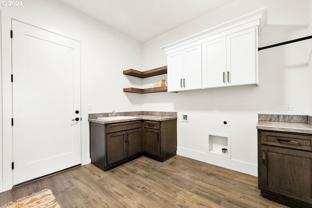 clothes washing area featuring hookup for a washing machine, wood-type flooring, hookup for an electric dryer, cabinets, and sink