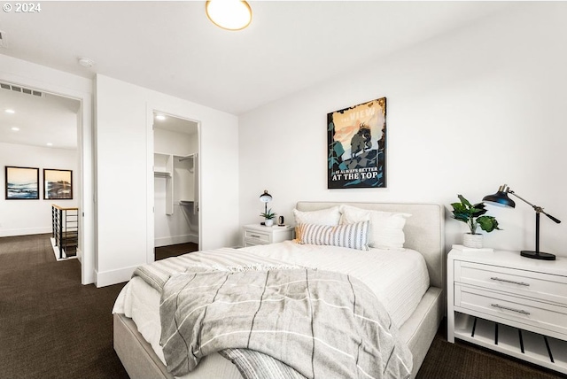 carpeted bedroom featuring a closet and a spacious closet