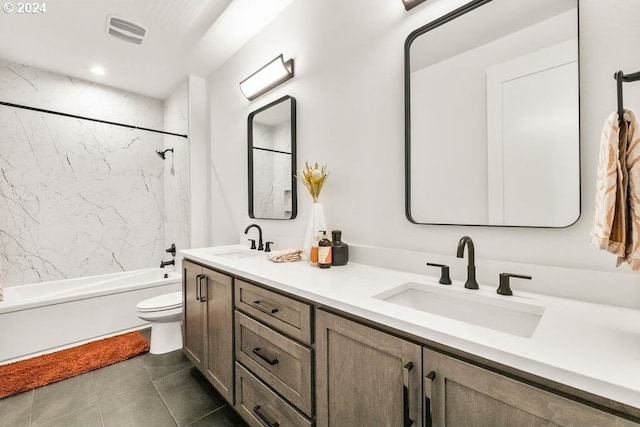 full bathroom featuring tiled shower / bath, toilet, tile floors, and dual vanity