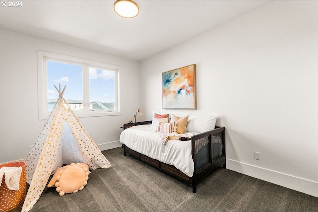 bedroom with dark colored carpet