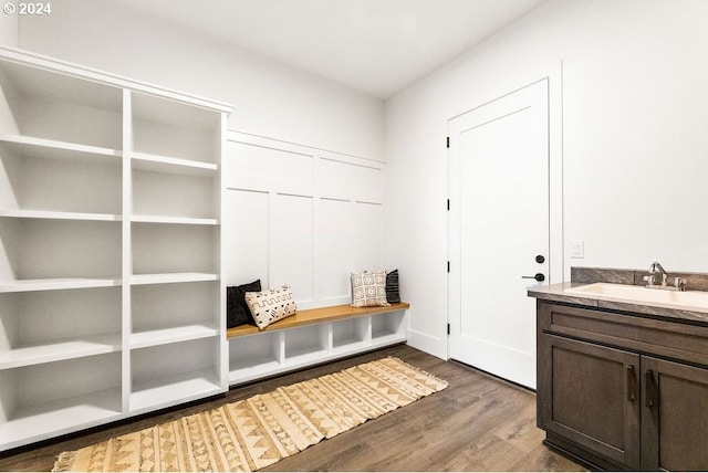 mudroom with dark hardwood / wood-style floors and sink