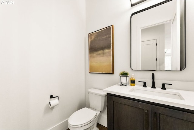 bathroom with toilet and large vanity