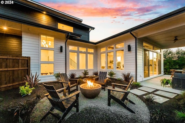 exterior space with an outdoor fire pit and ceiling fan