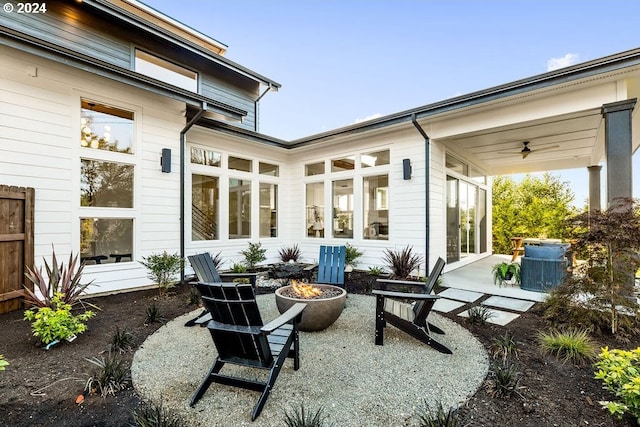 view of terrace with an outdoor fire pit and ceiling fan