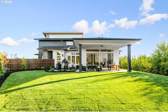 rear view of house featuring a lawn, a patio, and ceiling fan