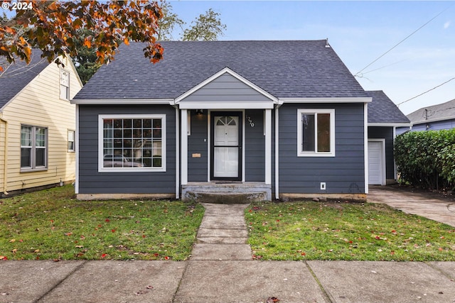 bungalow featuring a garage and a front yard