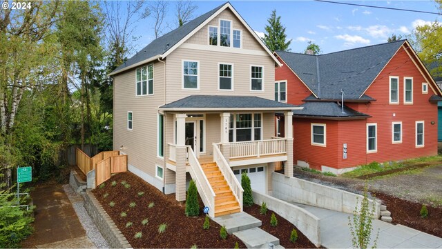 view of front of property with a porch and a garage