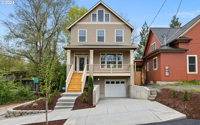 view of front of home featuring a porch and a garage