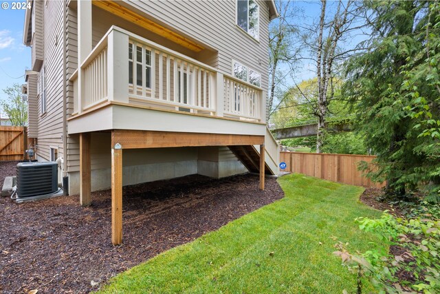 back of property featuring a yard and central AC unit