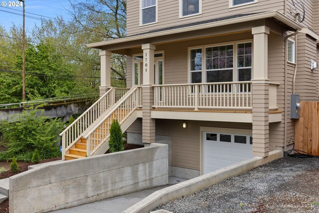 view of front of property featuring covered porch and a garage