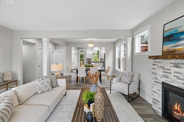 living room with a fireplace and dark wood-type flooring