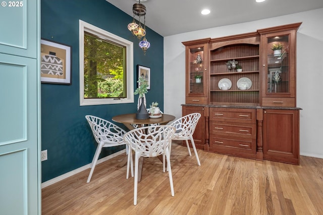 dining space with light wood-style floors, baseboards, and recessed lighting