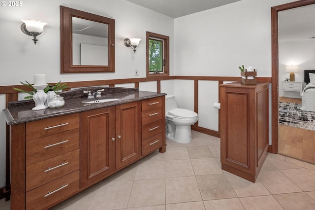 bathroom with vanity, tile patterned flooring, and toilet