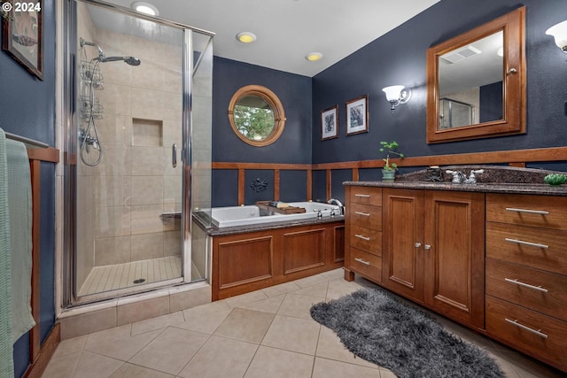 bathroom featuring tile patterned flooring, vanity, and shower with separate bathtub