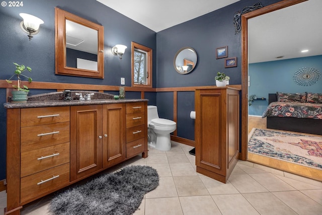 bathroom featuring tile patterned floors, vanity, and toilet