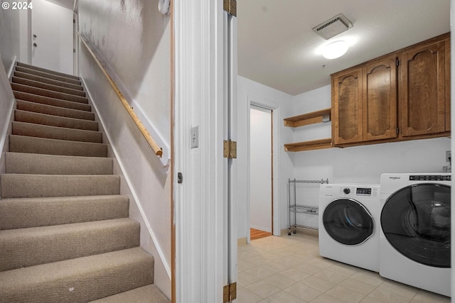 laundry area with cabinets and independent washer and dryer