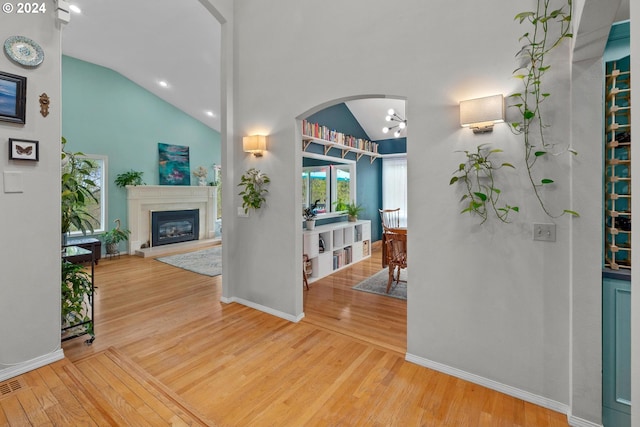 interior space featuring light hardwood / wood-style floors and lofted ceiling