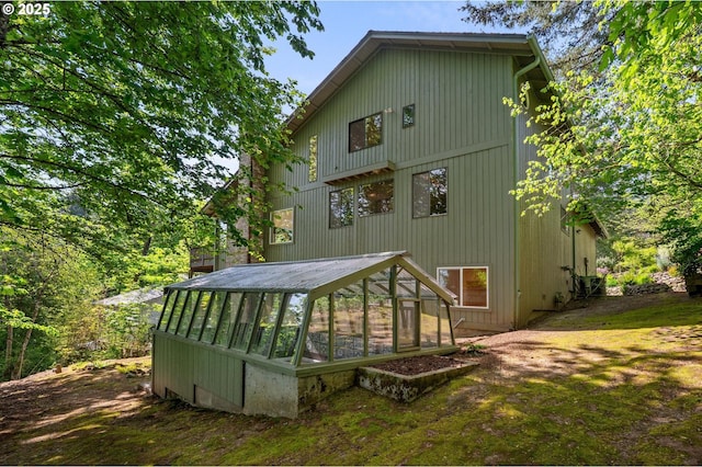 rear view of property featuring an outbuilding and an exterior structure