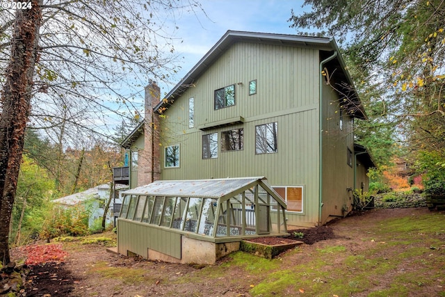 back of property with a sunroom