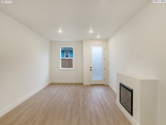 unfurnished living room with light hardwood / wood-style flooring