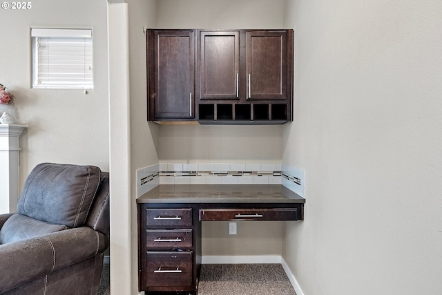 office space featuring baseboards and built in study area