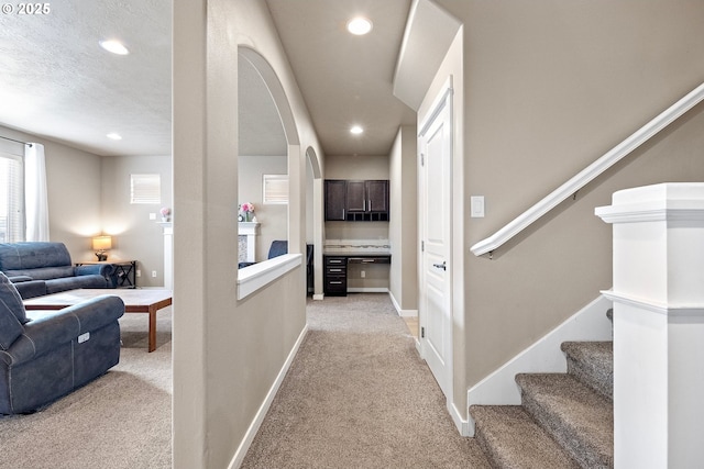 hall with recessed lighting, stairway, light carpet, and baseboards