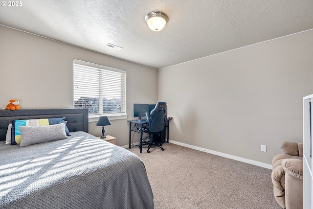 bedroom with carpet and a textured ceiling