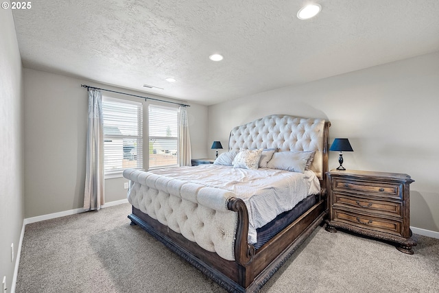 bedroom featuring carpet floors and a textured ceiling