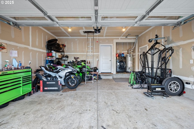 garage featuring a garage door opener, washer and clothes dryer, and water heater