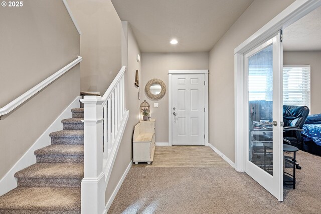 entrance foyer with carpet floors and french doors