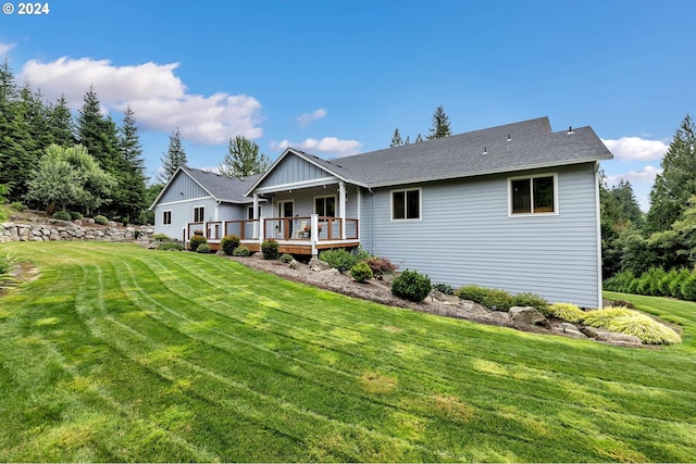 back of house with a lawn